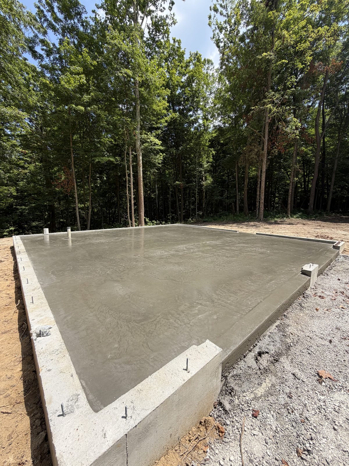 Finished ready-mix concrete slab and foundation poured by Kelley Ready Mix on a wooded Batavia, OH lot